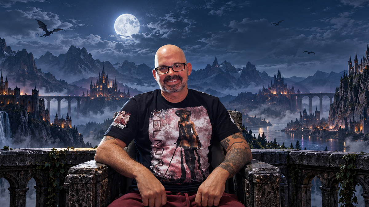 Wide banner of the Dragon Foxx® founder seated before the moonlit fantasy world of Drakoria, with gothic castles, waterfalls, and mountains behind him.